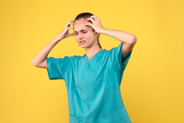 Front view female doctor in medical shirt having headache, health nurse covid-19 color emotion virus hospital