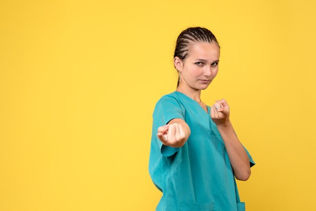 Front view female doctor in medical shirt, hospital covid-19 color health virus