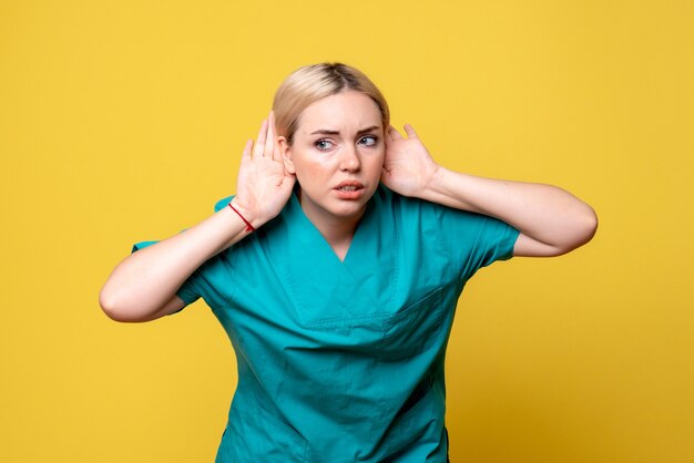 Front view female doctor in medical shirt listening, medic emotion nurse hospital covid pandemic