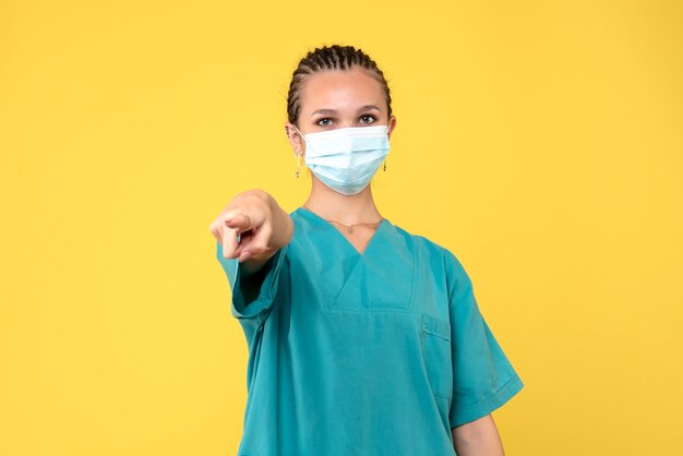 Front view female doctor in medical shirt and mask, health nurse hospital covid-19 pandemic