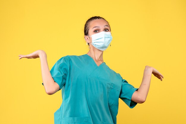 Front view female doctor in medical shirt and mask, health nurse virus pandemic hospital covid-