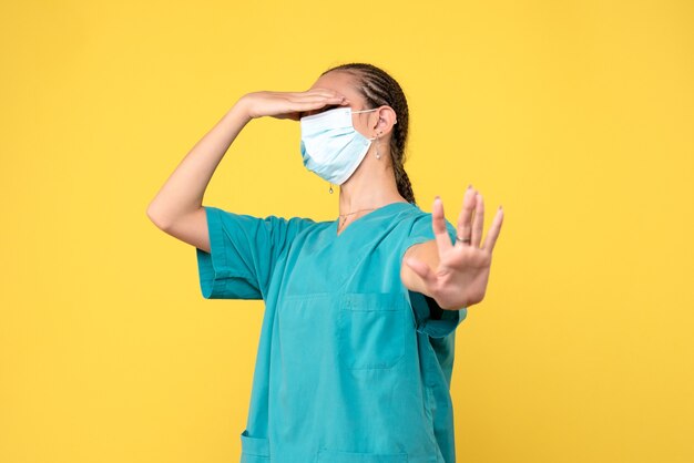 Front view female doctor in medical shirt and mask, medic health nurse virus pandemic covid-19 hospital