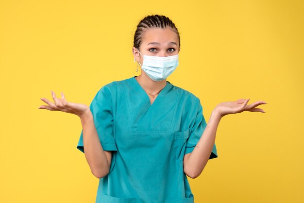 Front view female doctor in medical shirt and mask, medic health nurse virus pandemic covid-19 hospital