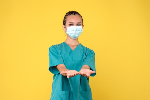Front view female doctor in medical shirt and mask, nurse pandemic hospital virus health covid-