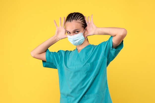 Front view female doctor in medical shirt and mask, pandemic health covid-19 hospital nurse virus