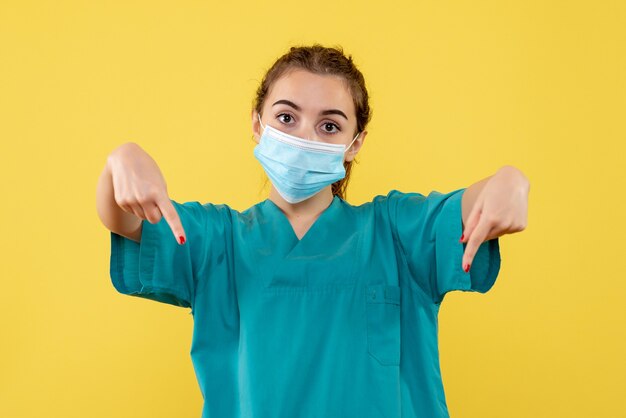 Front view female doctor in medical shirt and mask, pandemic uniform covid-19 health coronavirus