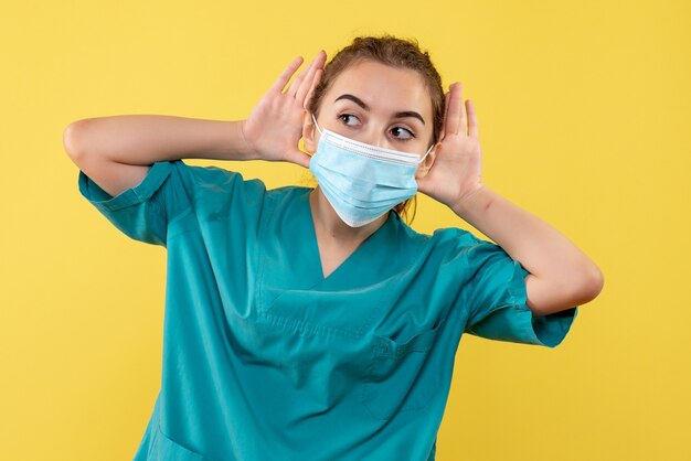 Front view female doctor in medical shirt and mask, virus pandemic covid-19 uniform coronavirus health