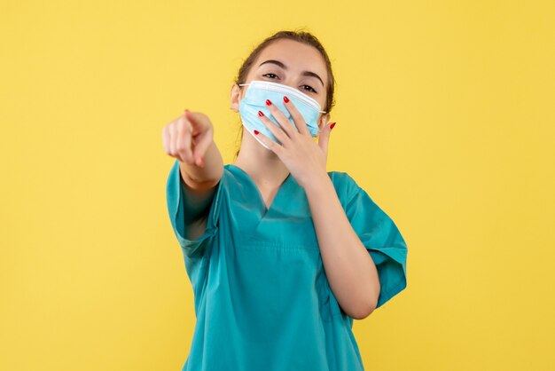 Front view female doctor in medical shirt and mask, virus pandemic uniform covid-19 coronavirus health