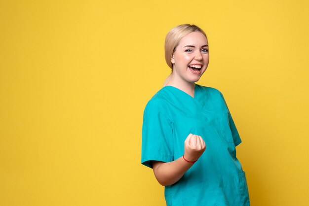 Front view female doctor in medical shirt, nurse hospital covid-19 pandemic emotion