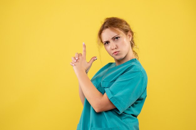 Front view female doctor in medical shirt posing, hospital medic covid-19 nurse color health medicine