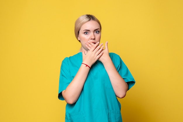 Front view female doctor in medical shirt scared, medic emotion covid-19 nurse pandemic