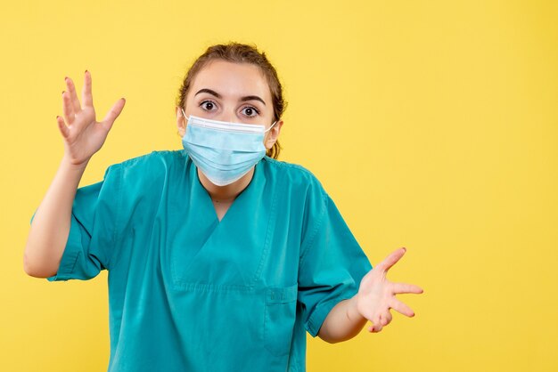 Front view female doctor in medical shirt and sterile mask, coronavirus uniform virus covid-19 pandemic health