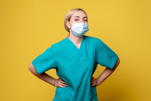 Front view female doctor in medical shirt and sterile mask, hospital medic nurse health covid pandemic