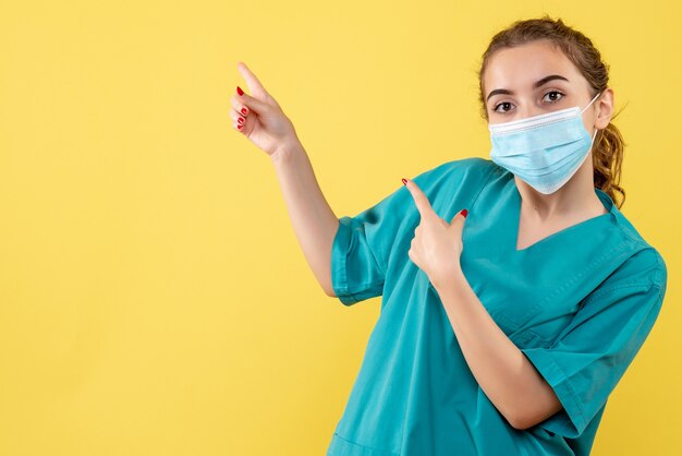 Front view female doctor in medical shirt and sterile mask, illness coronavirus uniform virus covid health