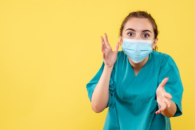 Front view female doctor in medical shirt and sterile mask, illness coronavirus virus covid pandemic health