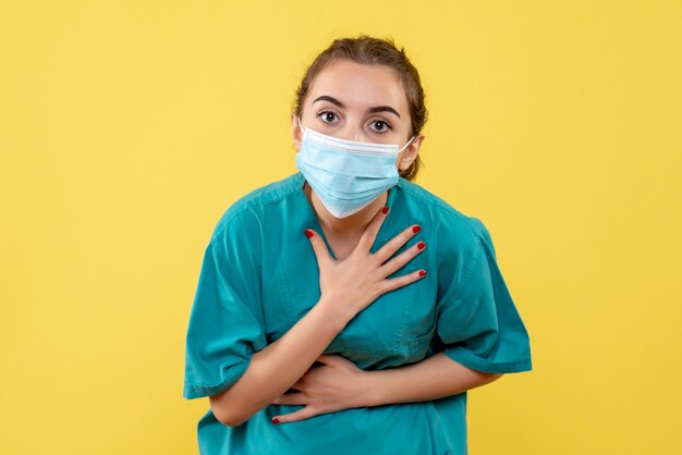 Front view female doctor in medical shirt and sterile mask, virus covid-19 coronavirus pandemic health