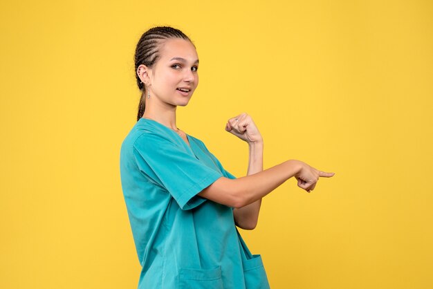 Front view female doctor in medical shirt, virus health emotion covid color