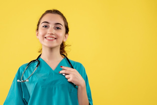 Free photo front view female doctor in medical shirt, virus uniform color emotion covid-19 health