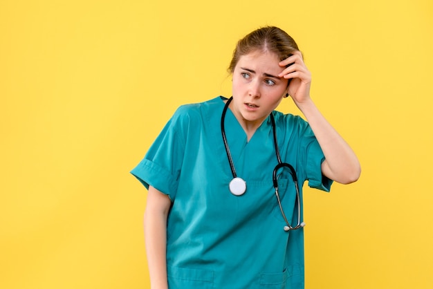 Free photo front view female doctor nervous on yellow background emotion hospital health medic