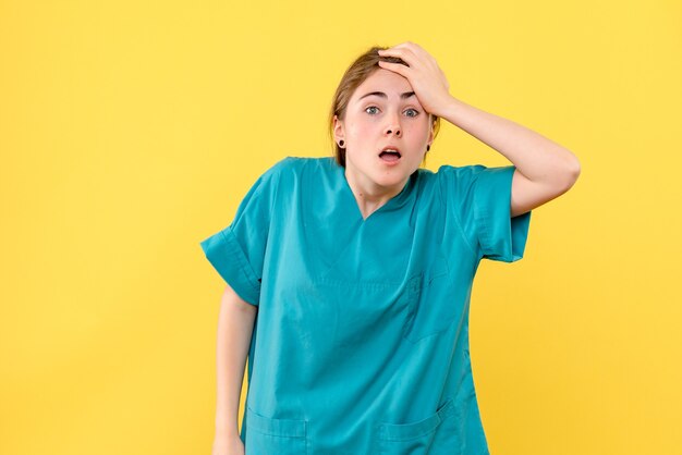 Free photo front view female doctor nervous on yellow background health emotion hospital medic