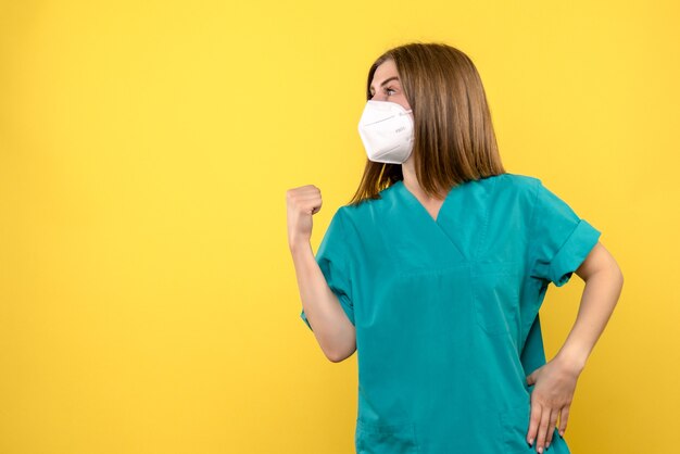 Front view female doctor posing on the yellow space