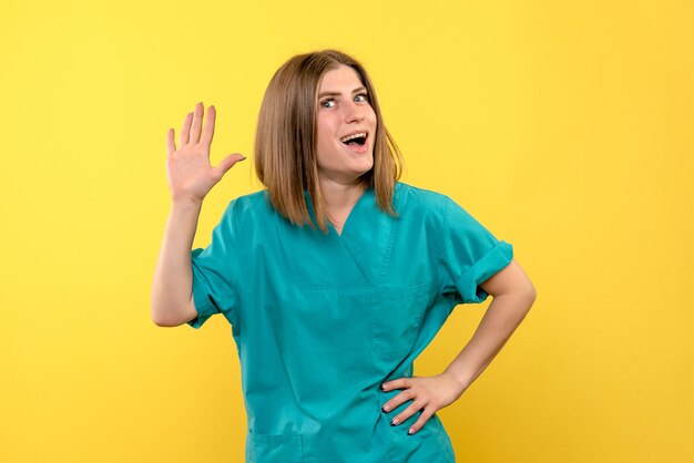 Front view female doctor posing on yellow space