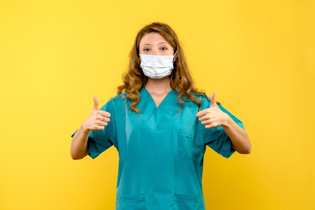 Front view female doctor posing on yellow space