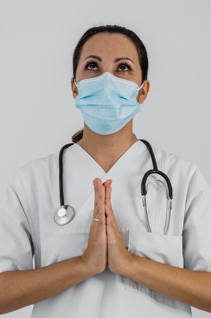 Front view of female doctor praying