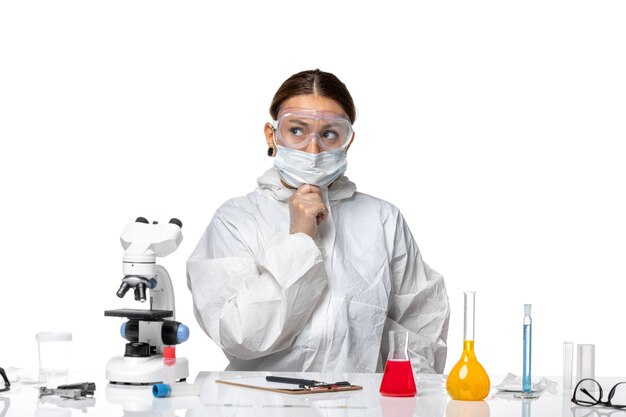 Front view female doctor in protective suit and with mask posing on white background virus medicine covid health pandemic