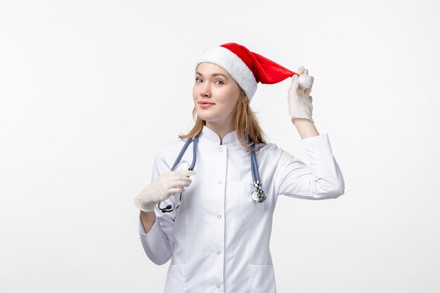 Free photo front view of female doctor smiling on a white wall