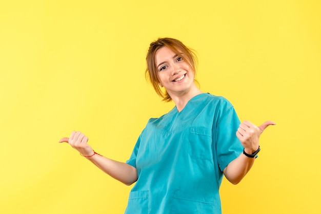 Front view female doctor smiling on yellow space