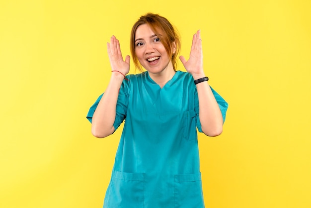 Front view female doctor smiling on yellow space