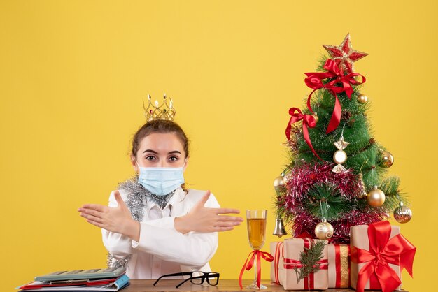 Front view female doctor in sterile mask with crown