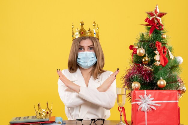 Front view female doctor in sterile mask with crown