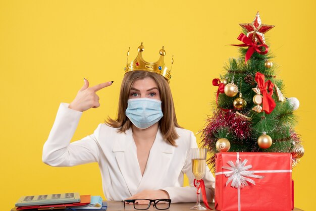 Front view female doctor in sterile mask with crown