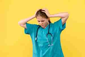 Free photo front view female doctor stressed on yellow background emotion medic hospital health