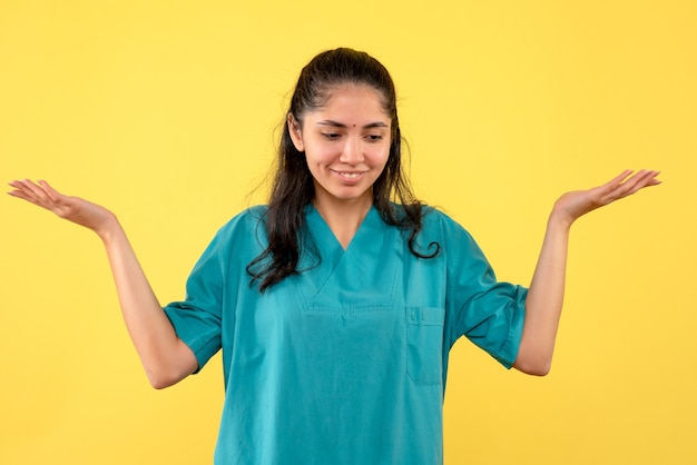 Front view female doctor in uniform opening hands standing