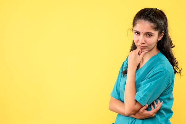 Front view female doctor in uniform putting hand