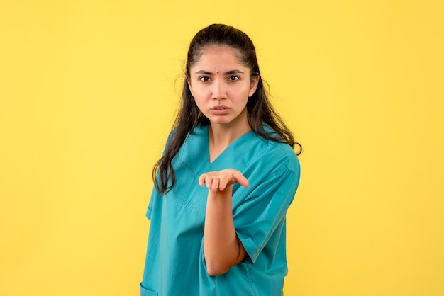 Front view female doctor in uniform sending kiss standing