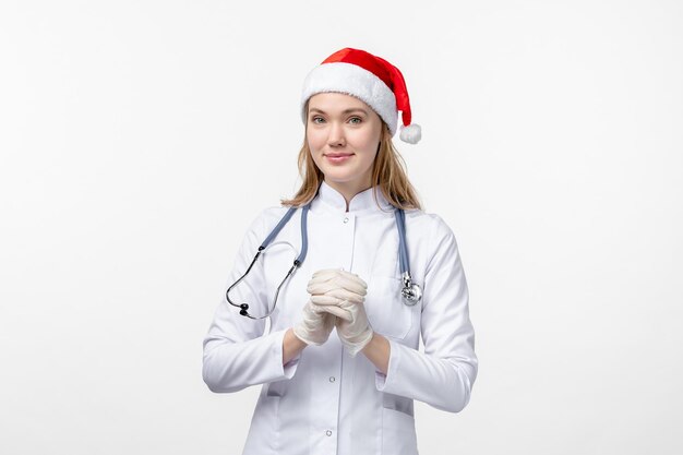 Front view of female doctor wearing gloves on the white wall