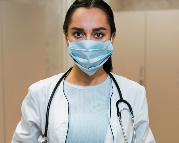 Front view female doctor wearing medical mask