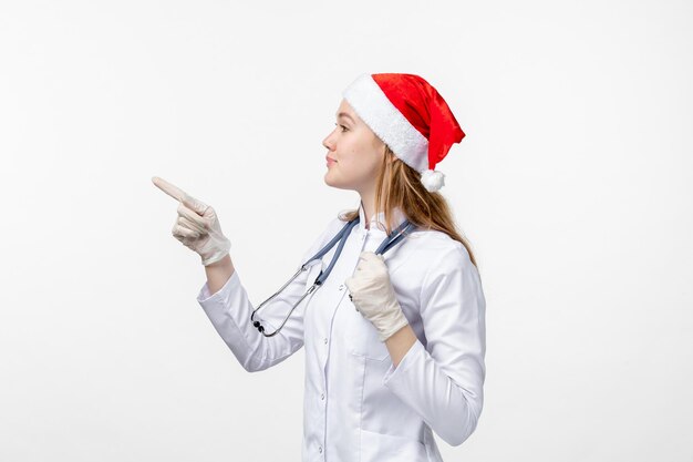 Front view of female doctor on the white wall