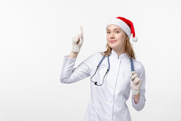 Front view of female doctor on white wall