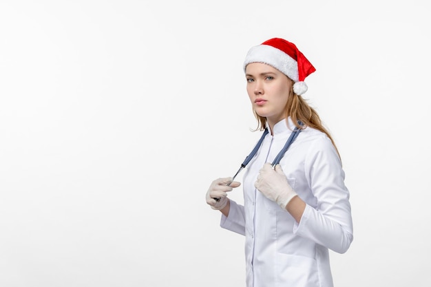 Front view of female doctor on white wall