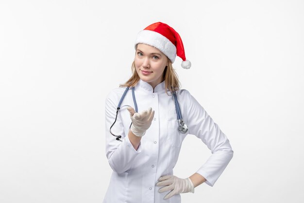 Front view of female doctor on white wall