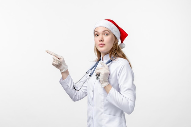 Front view of female doctor on white wall