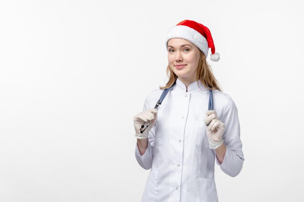 Front view of female doctor on white wall