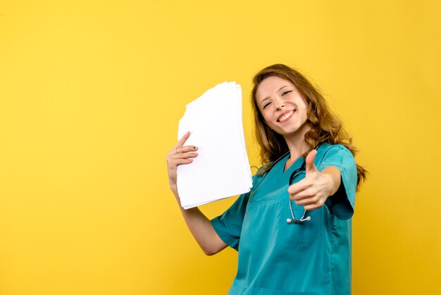 Front view female doctor with files on yellow space