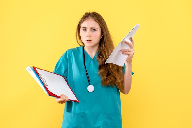 Front view of female doctor with medical files