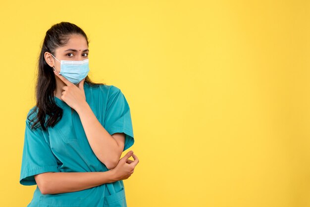 Front view female doctor with medical mask putting hand